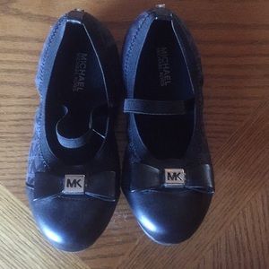 Black Michael Kors slip on shoes.